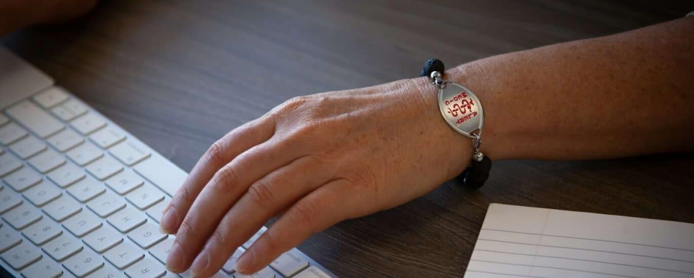 person wearing silver round analog watch